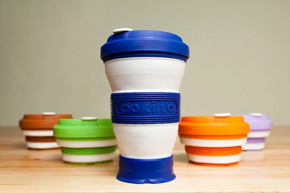 Colorful reusable coffee cups displayed.
