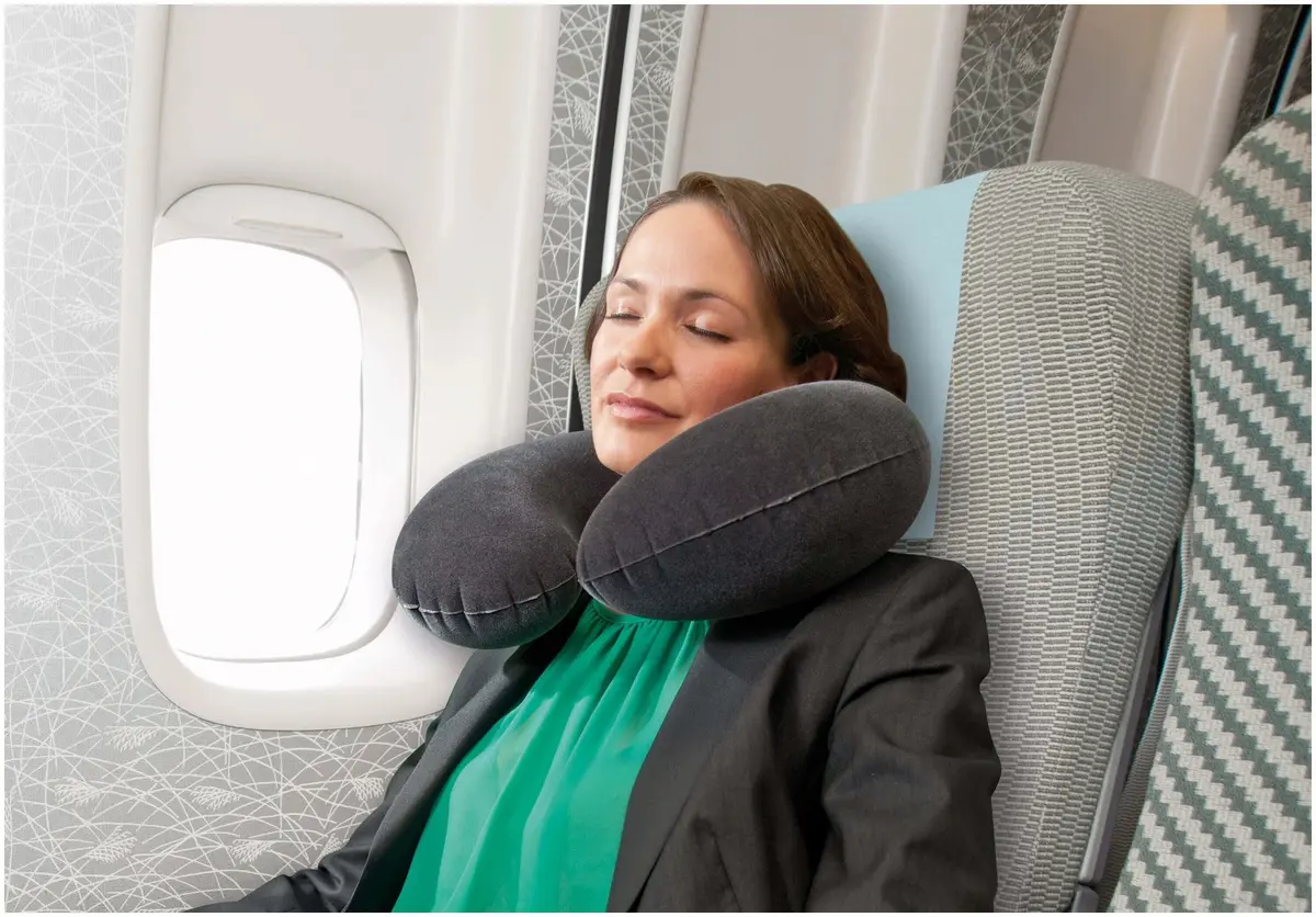 Person resting with travel neck pillow.
