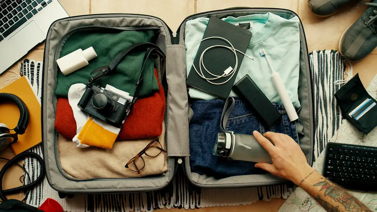 Packed suitcase with travel essentials.
